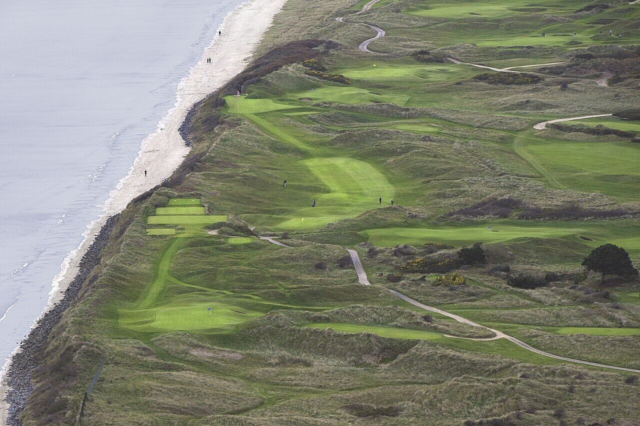 Aerial view of links holes running beside a beach at Portmarnock Golf Club.